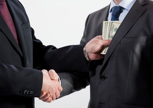 bribery Giving bribe into a pocket