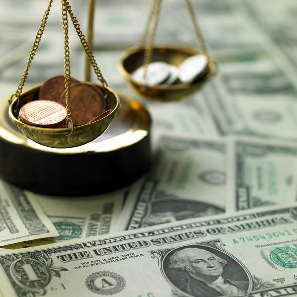 finance/a scale and coins on a paper money