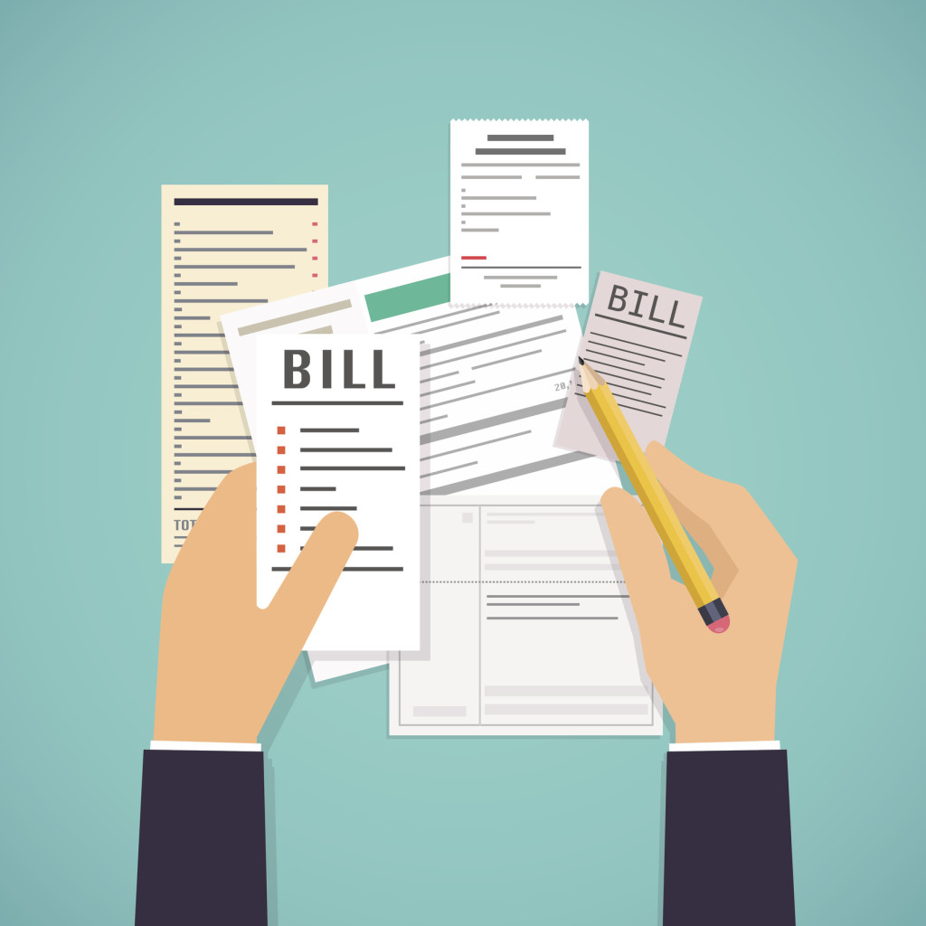 Paying bills. Hands holding bills and pencil. Payment of utility