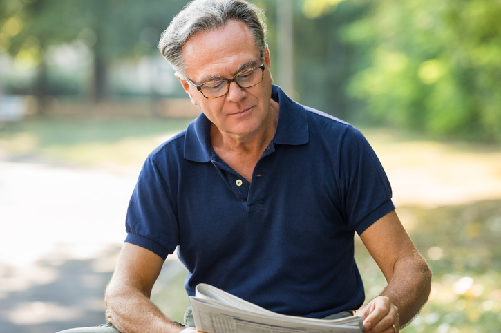 Senior man reading newspaper