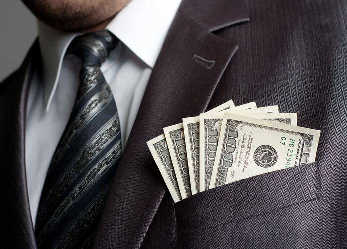 Businessman with money in suit pocket pay raises