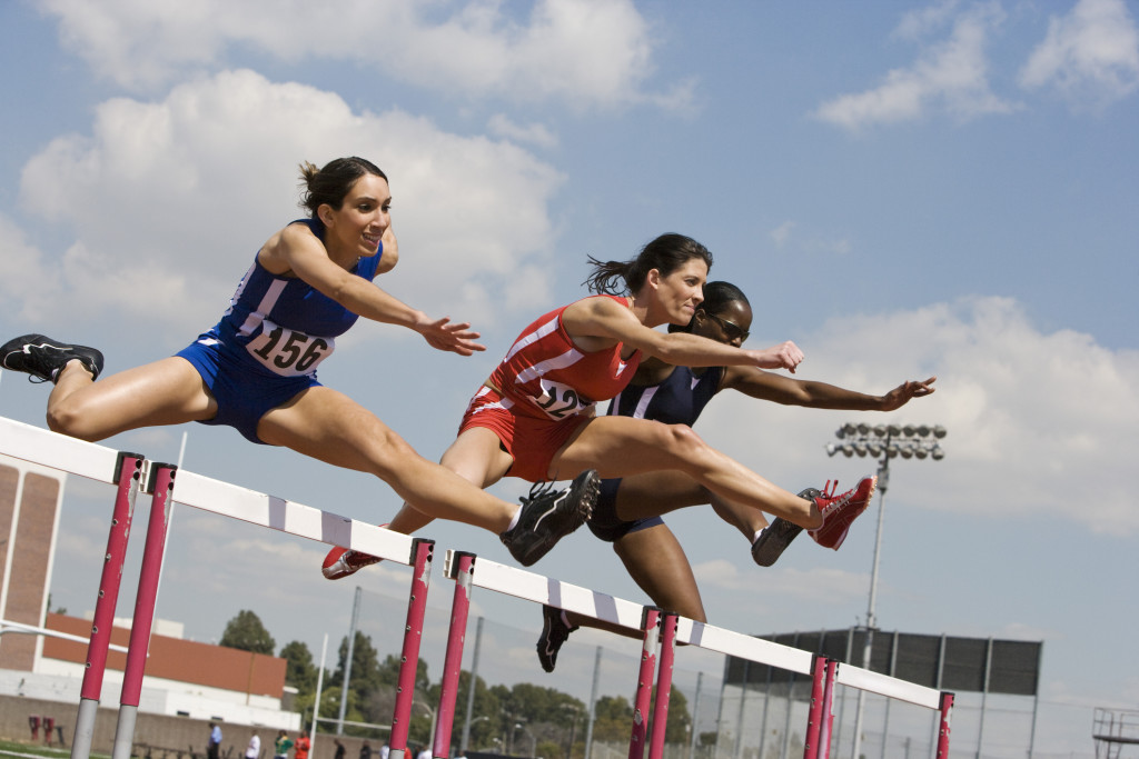 Female athletes hurdling