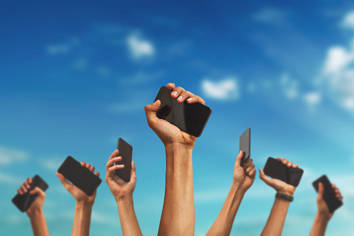 digital_revolution group of hands holding mobile phones
