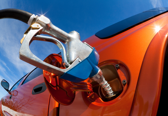 Pumping Gas Into Gas-Guzzler on a Sunny Day