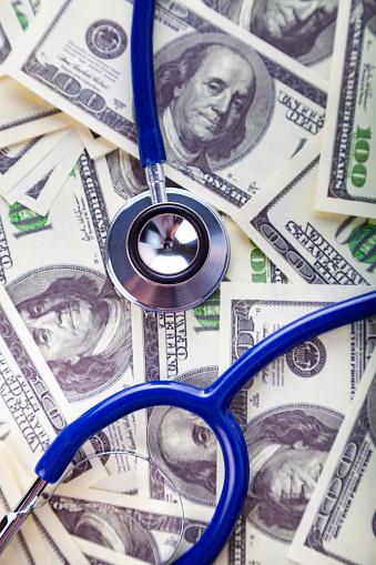 Stethoscope on dollars.