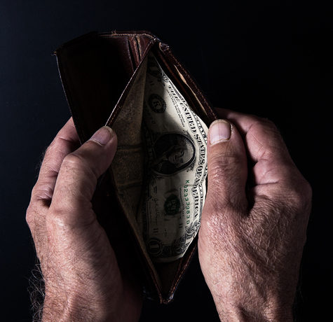 Old man with one dollar in the wallet