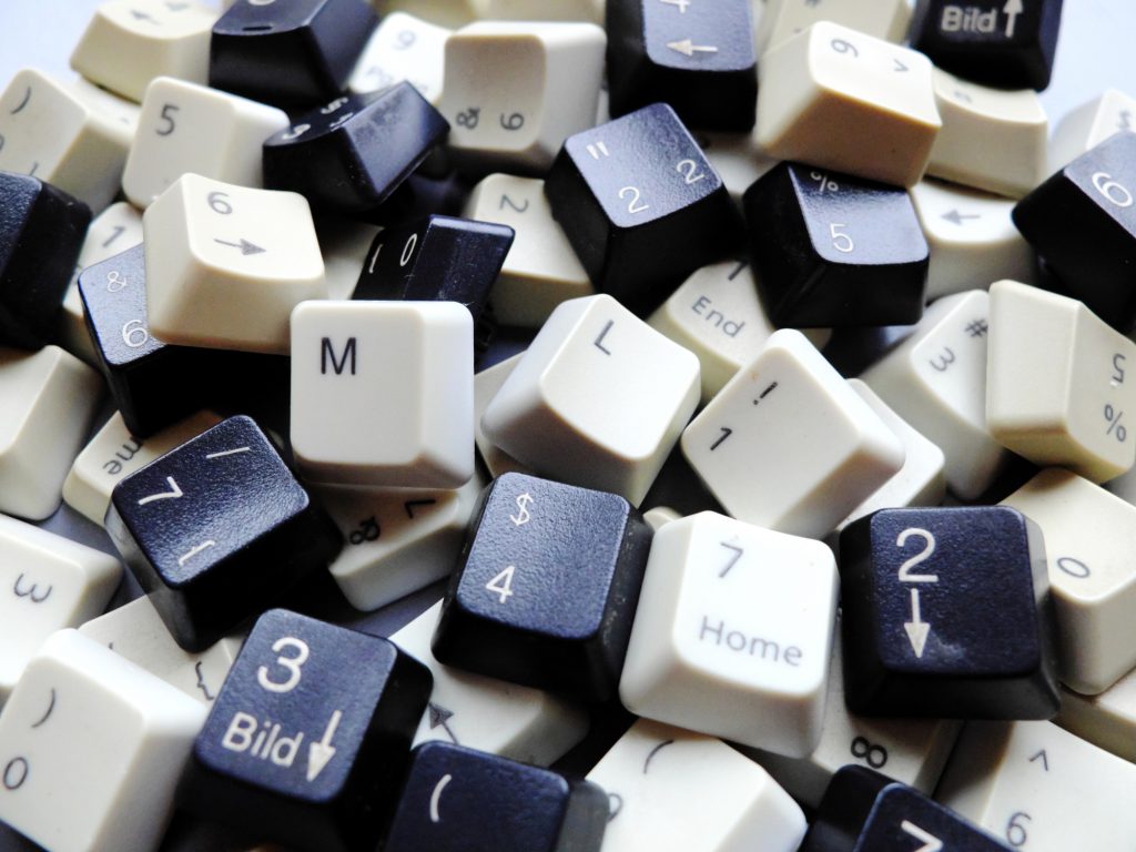 Black and white computer keyboard keys, mostly numeric with ML (Machine learning) buttons at the front. Concept of unstructured big data that need to be sorted ready to be consumed by ML or deep learning.