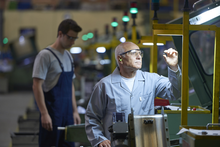 Worker looking at product in bolt factory
