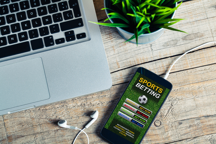 Mobile phone with sports betting website app in the screen.