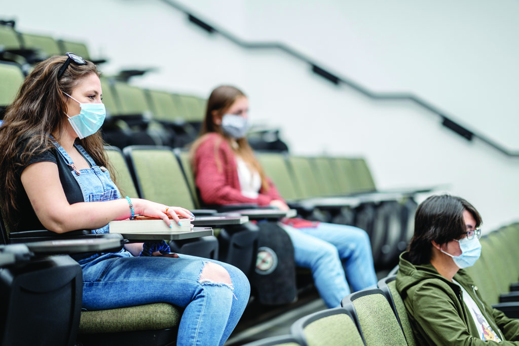 Group of university students wearing masks in class